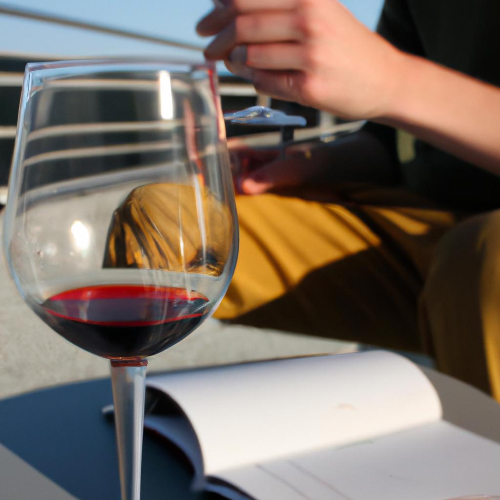 Person holding wine glass, studying